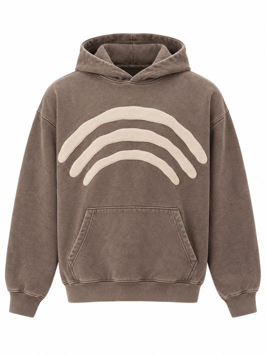 Front view of the Triple Arc washed mocha puff print boxy hoodie with three concentric cream puff-print arcs across the chest above the pocket