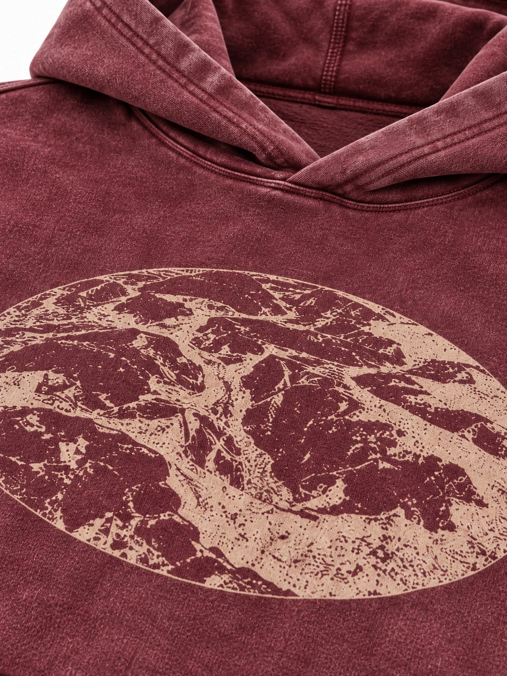 Close-up of the acid wash decoration on the Eroded Terrain burgundy acid wash boxy hoodie