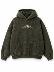 Front view of the Olive Fade olive acid wash oversized hoodie with small cream mountain artwork across the chest
