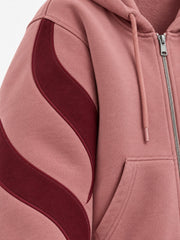 Close-up of the appliqué decoration on the Wave Panel dusty rose appliqué boxy zip-up hoodie