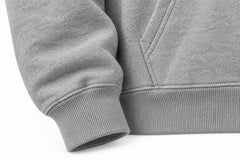 Close-up of the seam stitching of the Club 86 heather gray chenille boxy hoodie