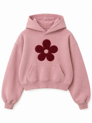 Front view of the Petal Club dusty pink chenille cropped hoodie with a large burgundy five-petal chenille flower
