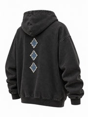 Rear three-quarter view of the Denim Letter washed black denim appliqué oversized hoodie