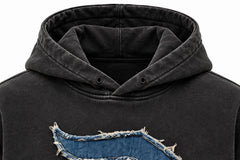 Close-up of the hood and neckline of the Denim Letter washed black denim appliqué oversized hoodie