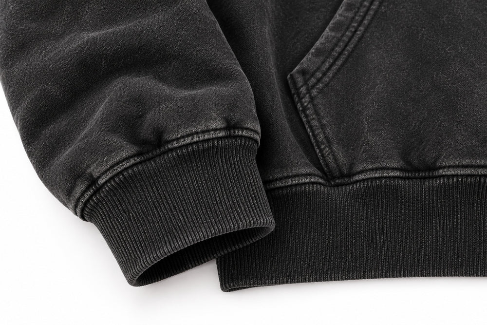 Close-up of the seam stitching of the Denim Letter washed black denim appliqué oversized hoodie