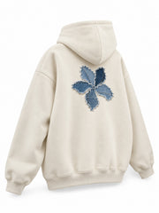 Rear three-quarter view of the Denim Petals cream denim appliqué oversized hoodie