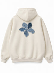 Back view of the Denim Petals cream denim appliqué oversized hoodie with a smaller matching denim flower