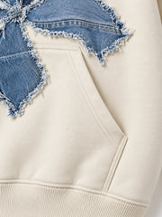 Close-up of the seam stitching of the Denim Petals cream denim appliqué oversized hoodie