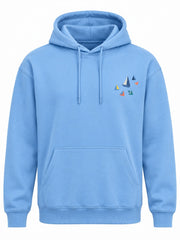 Front view of the Paper Coast sky blue DTF print hoodie with small cluster of colorful paper-boat sails on the chest