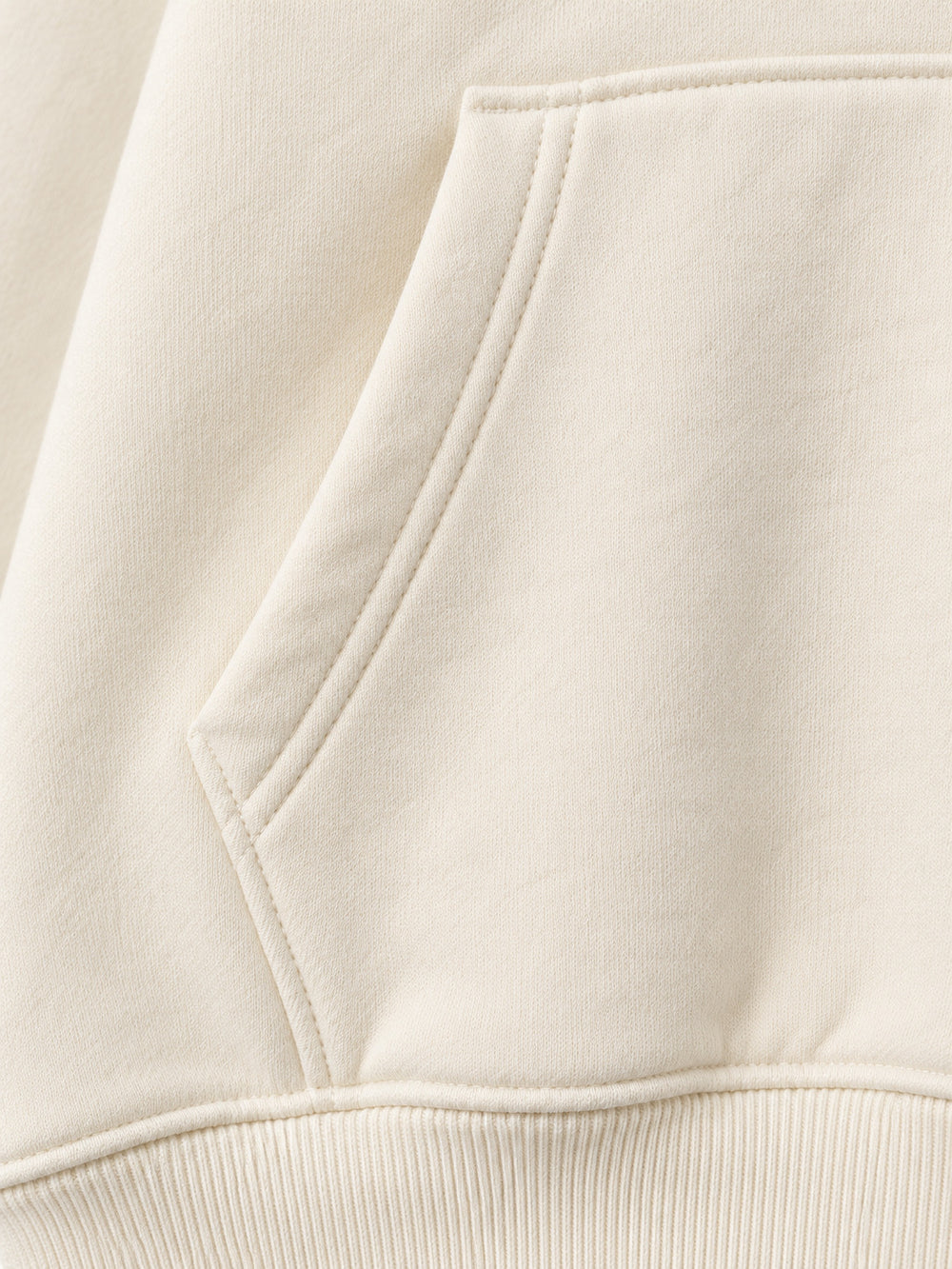 Close-up of the seam stitching of the Alpine Morning ecru DTG print oversized hoodie