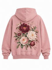 Back view of the Bloom Season faded pink DTG print oversized hoodie with large painterly peony bouquet in burgundy, cream and green, captioned BLOOM SEASON