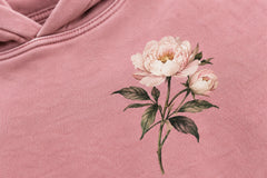 Close-up of the DTG print decoration on the Bloom Season faded pink DTG print oversized hoodie