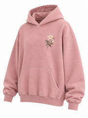 Front three-quarter view of the Bloom Season faded pink DTG print oversized hoodie