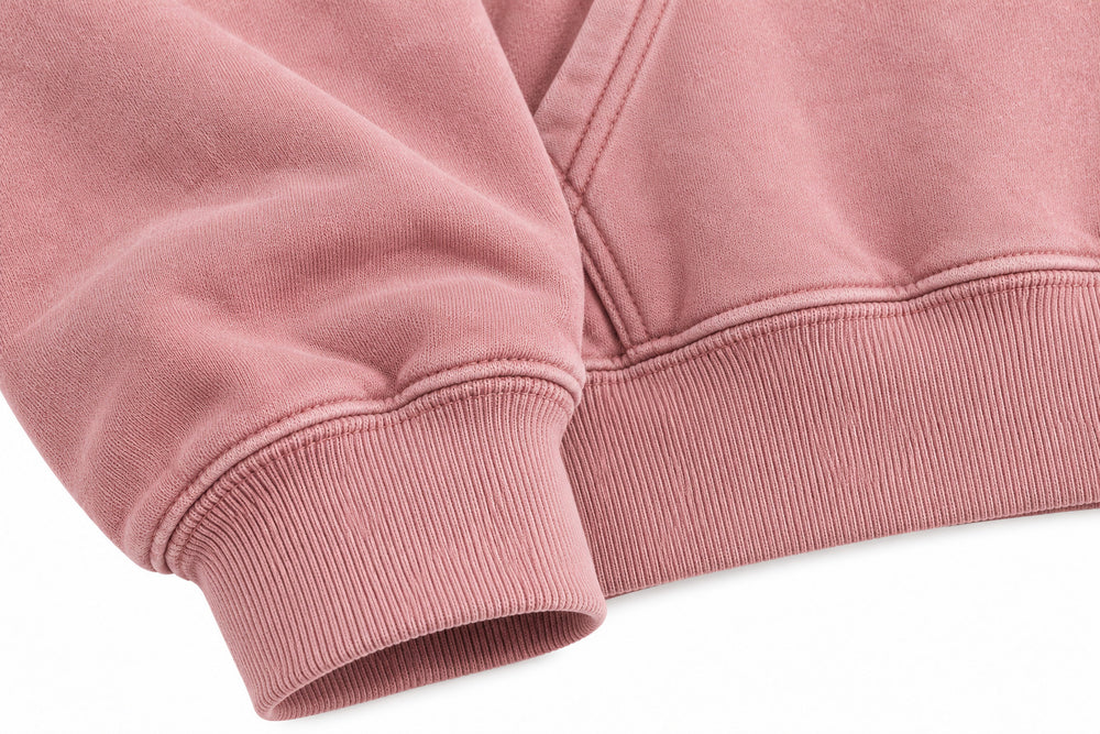Close-up of the seam stitching of the Bloom Season faded pink DTG print oversized hoodie