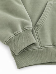 Close-up of the cuff and hem rib of the Botanical Archive sage DTG print hoodie