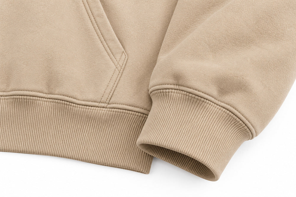 Close-up of the seam stitching of the Desert Echo sand DTG print boxy hoodie