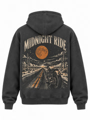 Back view of the Midnight Ride charcoal DTG print boxy hoodie with vintage motorcycle on a desert night road under a rust orange moon, captioned MIDNIGHT RIDE