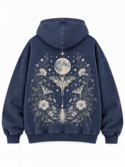 Back view of the Moon Garden washed indigo DTG print oversized hoodie with a moon, moth and botanical garden illustration