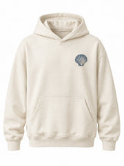 Front view of the Ocean Archive bone DTG print hoodie with small navy shell illustration on the left chest