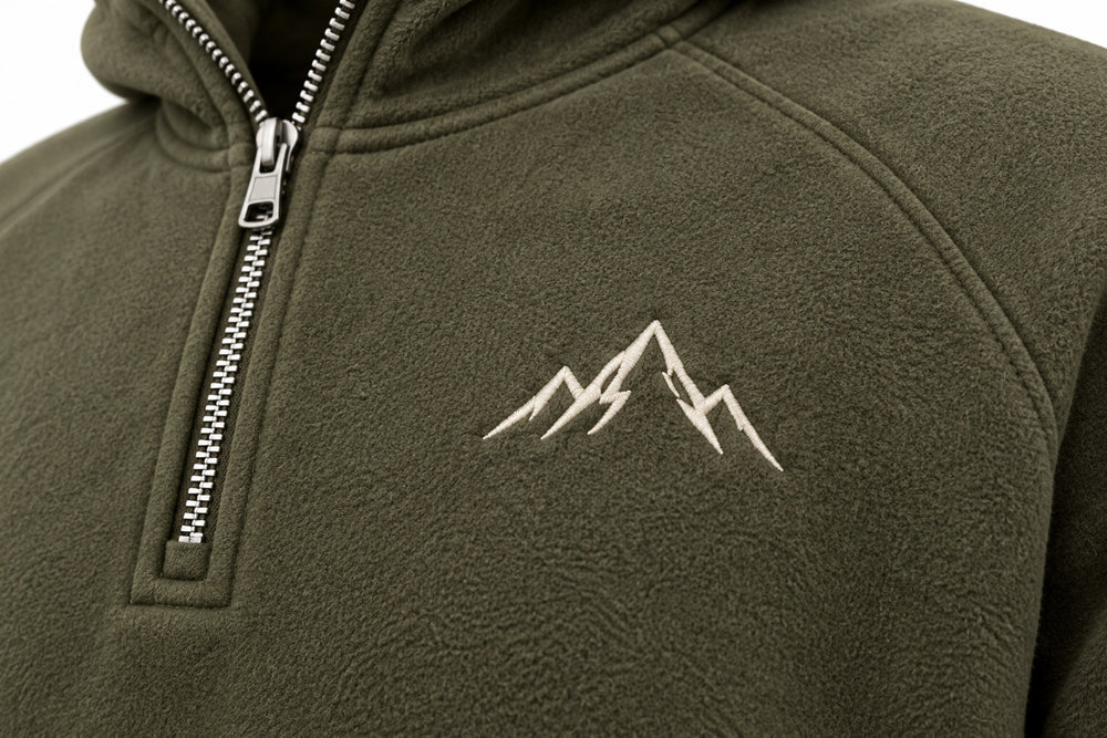 Close-up of the embroidered decoration on the Alpine Half Zip olive embroidered half-zip hoodie