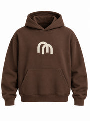 Front view of the Arc Atelier chocolate brown embroidered boxy hoodie with cream interlocking arch embroidery at the center chest