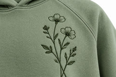 Close-up of the embroidered decoration on the Botanical Line sage embroidered hoodie