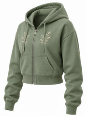 Front three-quarter view of the Botanical Zip sage embroidered cropped zip-up hoodie
