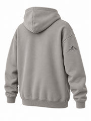 Rear three-quarter view of the Contour Club stone gray embroidered oversized hoodie