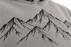 Close-up of the embroidered decoration on the Contour Club stone gray embroidered oversized hoodie