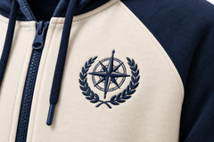 Close-up of the embroidered decoration on the Contrast Line ivory and navy embroidered zip-up hoodie