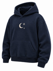 Front three-quarter view of the Crescent Studio midnight navy embroidered boxy hoodie