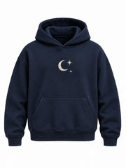 Front view of the Crescent Studio midnight navy embroidered boxy hoodie with ivory crescent moon and two stars embroidered at the center chest