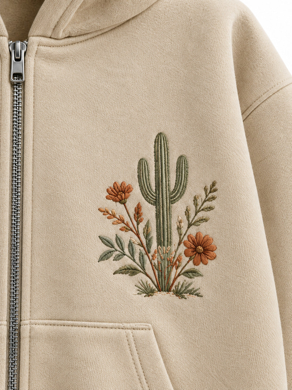 Close-up of the embroidered decoration on the Desert Bloom sand embroidered zip-up hoodie