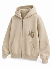 Front three-quarter view of the Desert Bloom sand embroidered zip-up hoodie