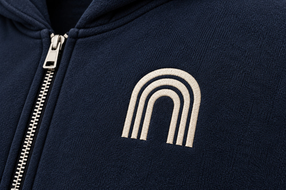 Close-up of the embroidered decoration on the Double Zip Arc navy embroidered boxy zip-up hoodie