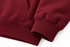 Close-up of the seam stitching of the Field Service burgundy embroidered hoodie
