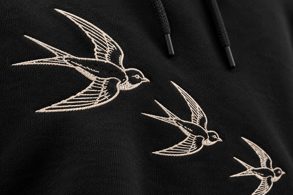 Close-up of the embroidered decoration on the Flight Line black embroidered hoodie