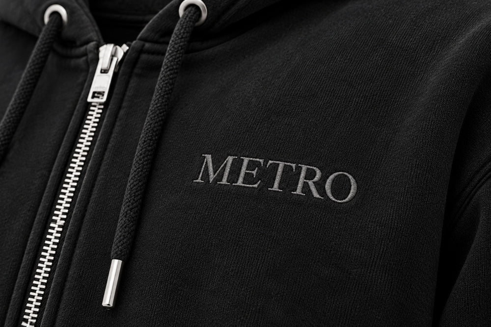 Close-up of the embroidered decoration on the Metro Zip black embroidered zip-up hoodie