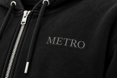 Close-up of the embroidered decoration on the Metro Zip black embroidered zip-up hoodie
