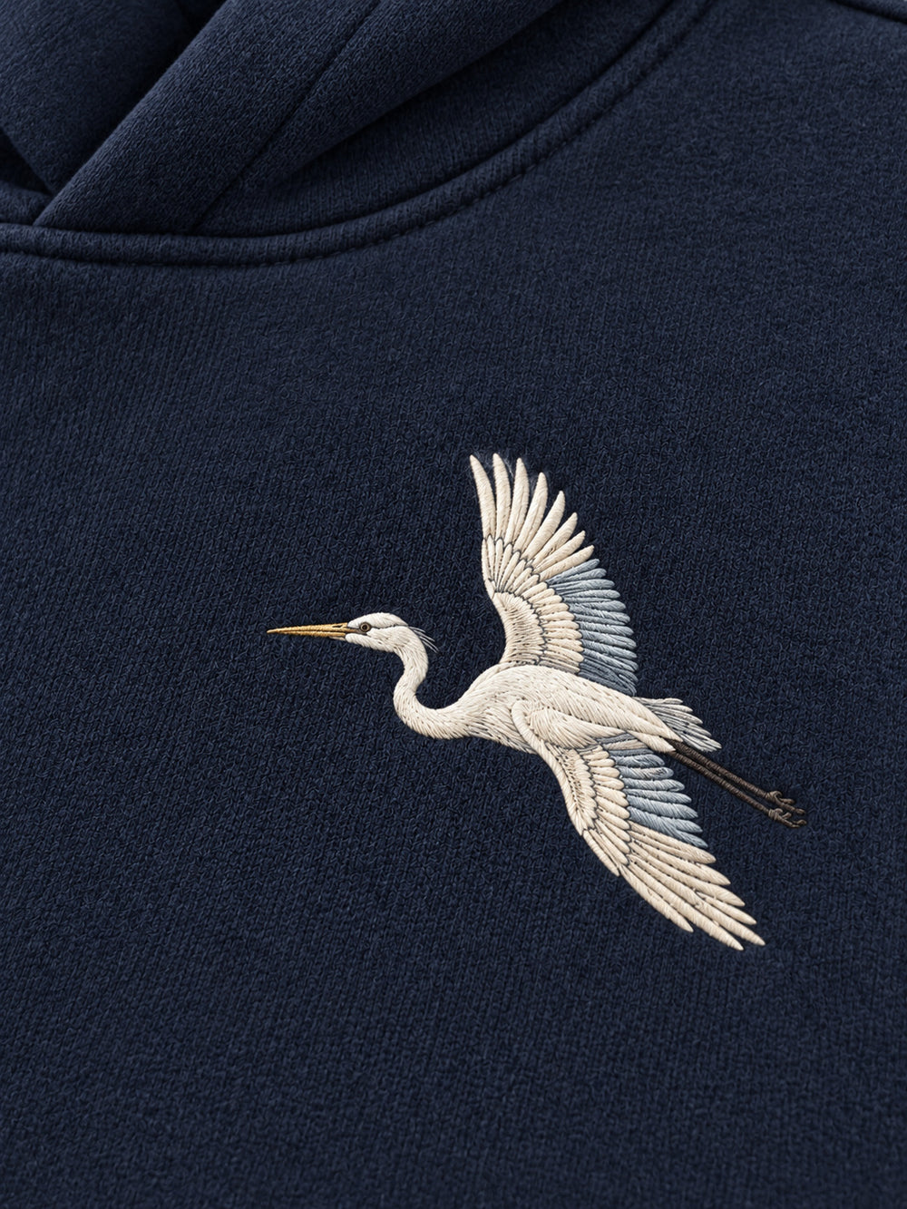 Close-up of the embroidered decoration on the Night Heron ink navy embroidered oversized hoodie
