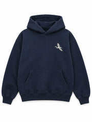 Front view of the Night Heron ink navy embroidered oversized hoodie with a small ivory heron embroidered at the left chest