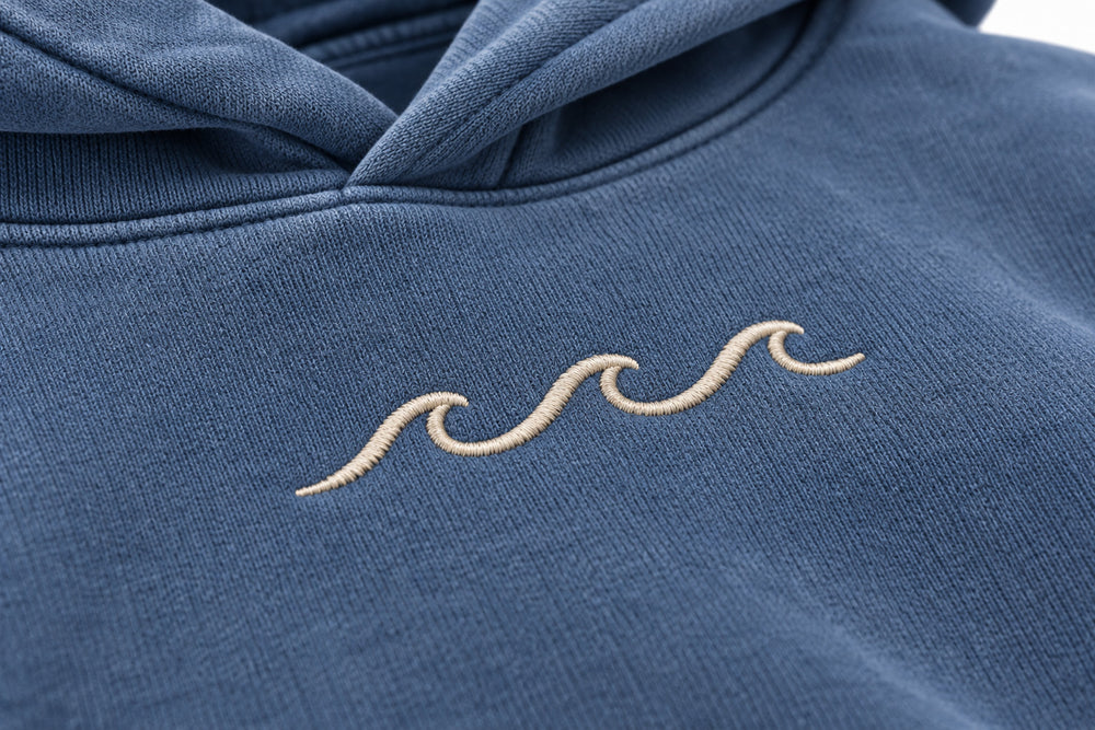 Close-up of the embroidered decoration on the Ocean Mark washed blue embroidered hoodie