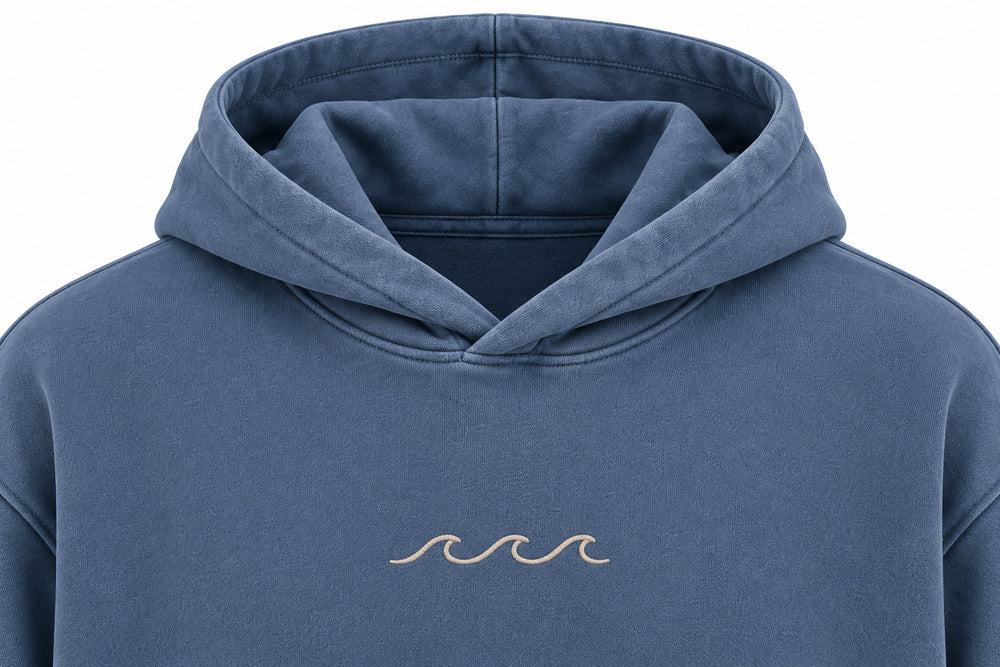 Close-up of the hood and neckline of the Ocean Mark washed blue embroidered hoodie