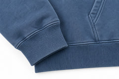 Close-up of the seam stitching of the Ocean Mark washed blue embroidered hoodie