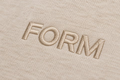 Close-up of the embroidered decoration on the Quiet Form oatmeal embroidered oversized hoodie
