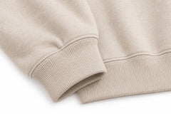 Close-up of the seam stitching of the Quiet Form oatmeal embroidered oversized hoodie