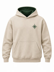 Front view of the Trail Compass warm sand embroidered hoodie with forest green compass embroidered on the left chest