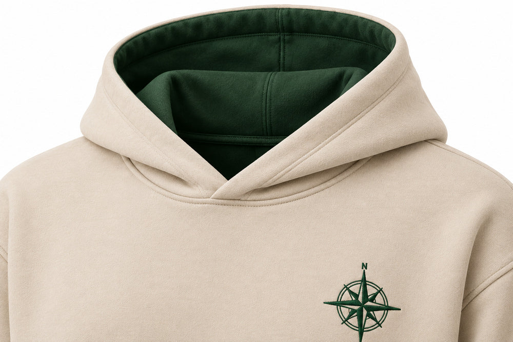 Close-up of the hood and neckline of the Trail Compass warm sand embroidered hoodie