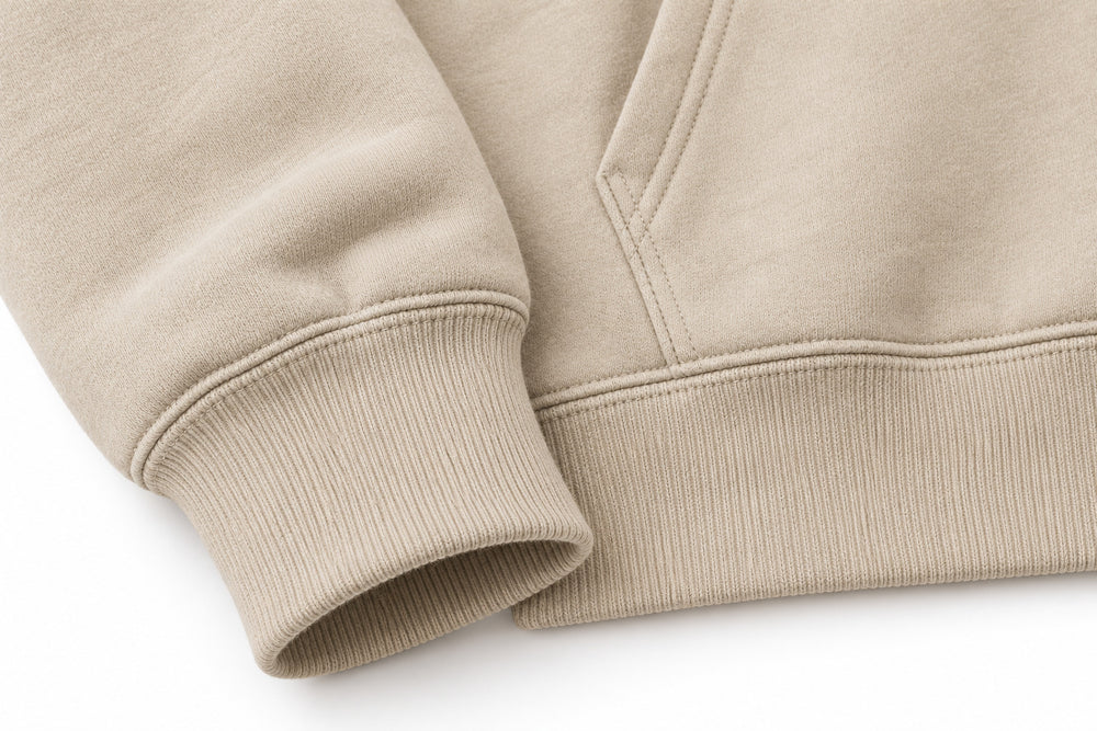 Close-up of the seam stitching of the Trail Compass warm sand embroidered hoodie