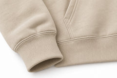 Close-up of the seam stitching of the Trail Compass warm sand embroidered hoodie